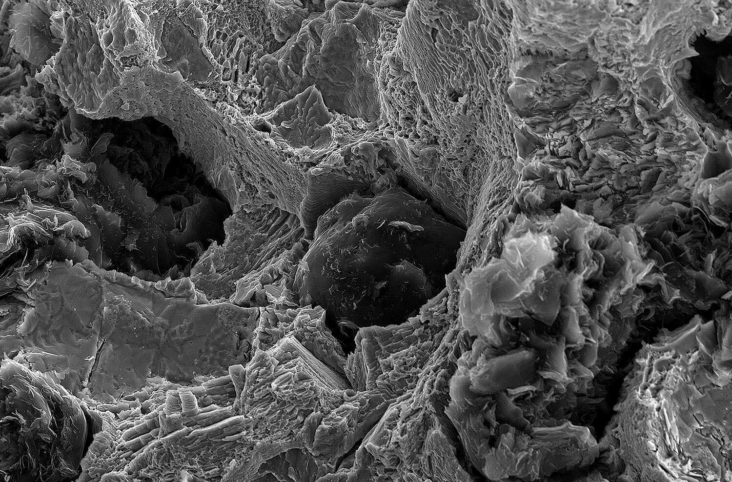 iron casting- spheroidal graphite cast iron -microscope the microscope shows spherulites in ductile cast iron used for engineered iron castings made of EN-GJL , EN-GJS, ADI, SiMo and NiResist